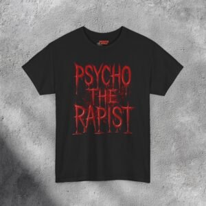 The T-shirt features bold, dripping red text reading “PSYCHO THE RAPIST” stacked in three lines against a dark black background. The letters appear glossy and wet, resembling fresh blood or thick paint, with realistic reflections and shadows adding depth. Behind the text, subtle red splatters and stains spread outward, enhancing the disturbing, horror-inspired aesthetic. The shirt’s fabric texture shows faintly beneath the design, making it feel gritty and raw — like a heavy metal or dark-humor statement piece with a shocking visual punch.